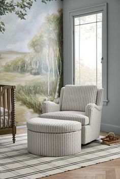 a living room with a large painting on the wall next to a chair and ottoman