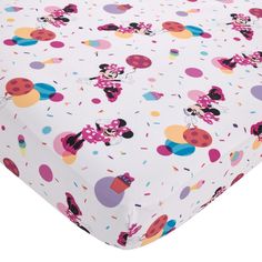 a white sheet with minnie mouses and polka dot dots on it's surface