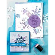 two cards with snowflakes on them, one has a purple ribbon and the other is