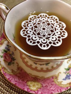 a tea cup filled with liquid sitting on top of a saucer