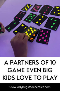 a person playing with some kind of game that is on the table and it has neon colors