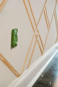 a piece of green tape is taped to the wall