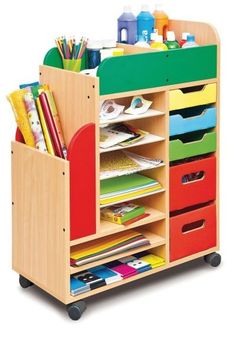 a child's wooden storage unit with lots of books and supplies on it,