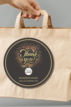 a person is holding a thank you bag