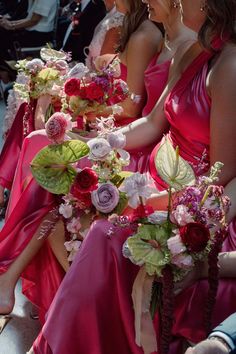 the bridesmaids are all wearing pink dresses and holding bouquets in their hands