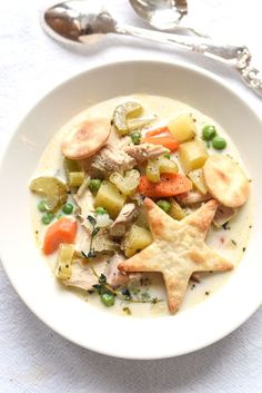 a white plate topped with meat and veggies