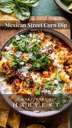 mexican street corn dip in a bowl with tortilla chips and cilantro