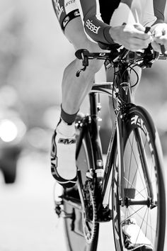 black and white photograph of a bicyclist using his cell phone