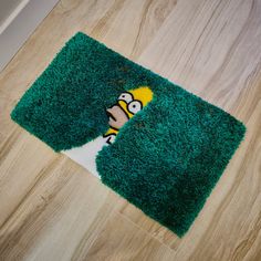 the rug is green and has a cartoon character on it