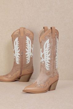 Embrace a feminine and flirty style at your next rodeo with the IDALY - Pastel Western Mid Boots. Crafted from smooth faux leather, these mid-calf boots are perfect for any festival scene, featuring a classic pointed-toe and intricate Western-inspired detailing in soft pink and beige hues. The curved topline with side pull tabs ensures easy on-and-off, while the wood-look stacked heel adds just the right amount of height. These boots combine charm and practicality, making them a must-have for th Trendy Summer Boots Medium Width, Western Style Pointed Toe Knee-high Boots For Fall, Western Knee-high Boots With Pointed Toe For Fall, Fall Wide Calf Knee-high Boots With Snip Toe, Spring Knee-high Boots With Reinforced Heel And Pointed Toe, Western Style Faux Leather Moto Boots For Fall, Fall Wide Calf Mid-calf Boots With Snip Toe, Spring Rodeo Moto Boots With Round Toe, Spring Pointed Toe Knee-high Boots With Stacked Heel