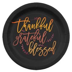 a brown paper plate with the words grateful written in orange and black ink on it