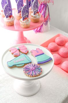 decorated cookies and cupcakes on a cake stand