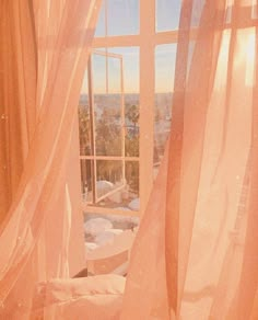 an open window with sheer curtains in front of it