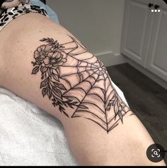 a woman with a spider web tattoo on her arm