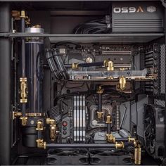 the inside of a computer case with gold trimmings and metal piping on it