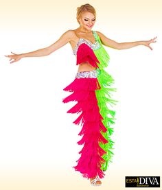 a woman in a pink and green belly dance costume with her arms out to the side