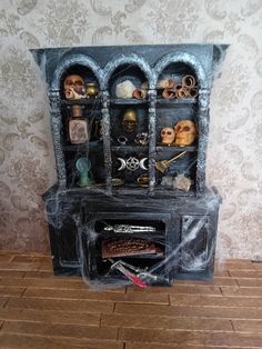 This is a witches cabinet that has been aged with paint and is full of witchy delights including skulls, scrolls, crystal ball, ouija board and crystals among other things. This is a collectors item and not for children. Witches Cabinet, Gothic Dollhouse, Ouija Board, Crystal Ball, Wedding Basket, Collectible Dolls, Dollhouse Miniatures, Armoire, Doll House