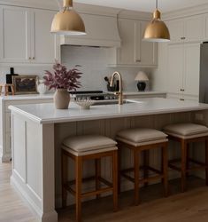 a kitchen island with stools next to it