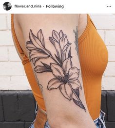 a woman with a flower tattoo on her arm