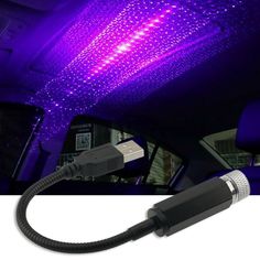 the inside of a car with purple lights and a usb cable plugged into it