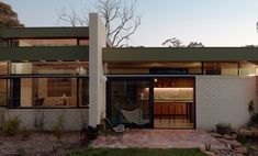 a modern house with glass doors and brick walls