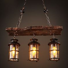 three lights hanging from a wooden beam