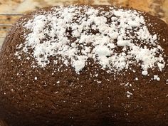 a chocolate cake with powdered sugar on top