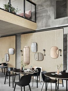 a room with tables, chairs and mirrors on the wall