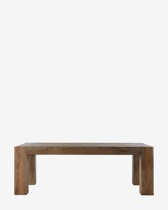 a wooden table sitting on top of a white wall