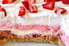 a cake with strawberries on top is cut in half and ready to be eaten