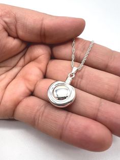 The Double Round Cremation Keepsake Necklace is designed with simplicity and grace, allowing you to keep a small portion of your loved one's ashes close to your heart. This subtle yet meaningful piece offers comfort and remembrance in a minimalist style. ❤️FREE Personalization: message can be engraved on the back or front of the pendant; 12 characters maximum each side. ❤️Size: about 3/4" diameter.  ❤️Material:  genuine 925 sterling silver ❤️Included in the package:18" matching silver chain,gift box, filling funnel kit; ❤️ Care Instructions: Though the materials used is made of sterling silver, I recommend you to not sleep, swim, or spray chemicals (i.e. perfumes, lotions, or body spray) on to the necklace to preserve its longevity. Please follow these tips to preserve the longevity of the Keepsake Necklace, Cremation Necklaces, Cremation Jewelry, Keepsake Jewelry, Memorial Jewelry, Simple Necklace, Body Spray, Minimalist Style, Sterling Silver Pendant