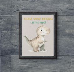 a framed photo of a little dinosaur with the words chase your dreams