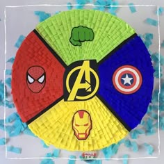 a paper plate with avengers symbols on it and confetti in the shape of an egg