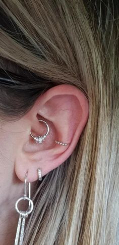 a close up of a person with ear piercings