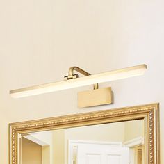 a bathroom mirror with a light on top of it