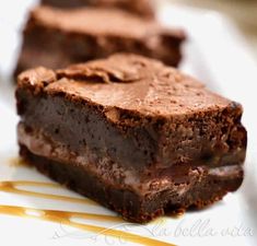 two pieces of brownie on a plate with caramel drizzle