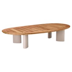 an oval wooden table with two white pedestals on each side and a circular wood top