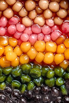 an assortment of fruits and vegetables are arranged in the shape of a rainbow colored flag