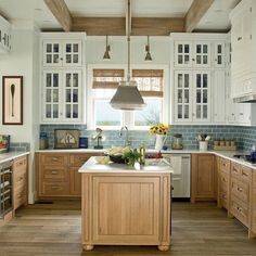 a kitchen filled with lots of wooden cabinets and counter top space next to an island