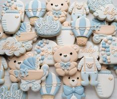 baby shower cookies with teddy bears and blue ones on them, all decorated in pastel colors