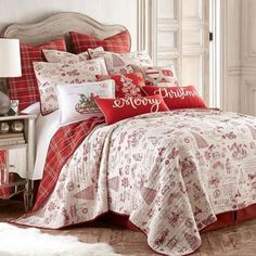 a bed covered in red and white comforters