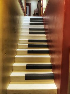 the stairs are lined with black and white stripes