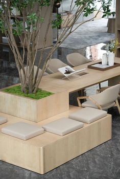 a table with chairs and a planter on it in the middle of a room