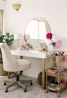 a white desk topped with a mirror next to a chair