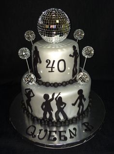 a cake decorated with disco balls and the number twenty