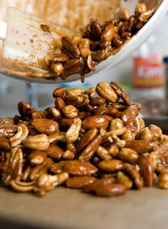 a bowl full of nuts is being scooped into it