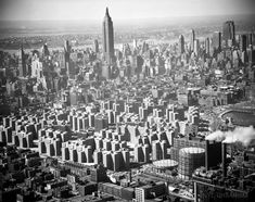 an aerial view of the city with tall buildings and skyscrapers in black and white