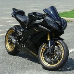 a black and gold motorcycle parked in a parking lot