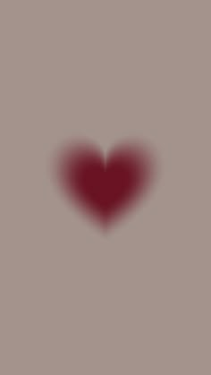 a red heart shaped shadow on a gray background with the word love written below it