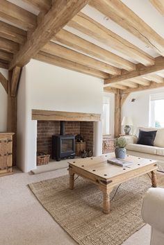 a living room filled with furniture and a fire place in the middle of a room